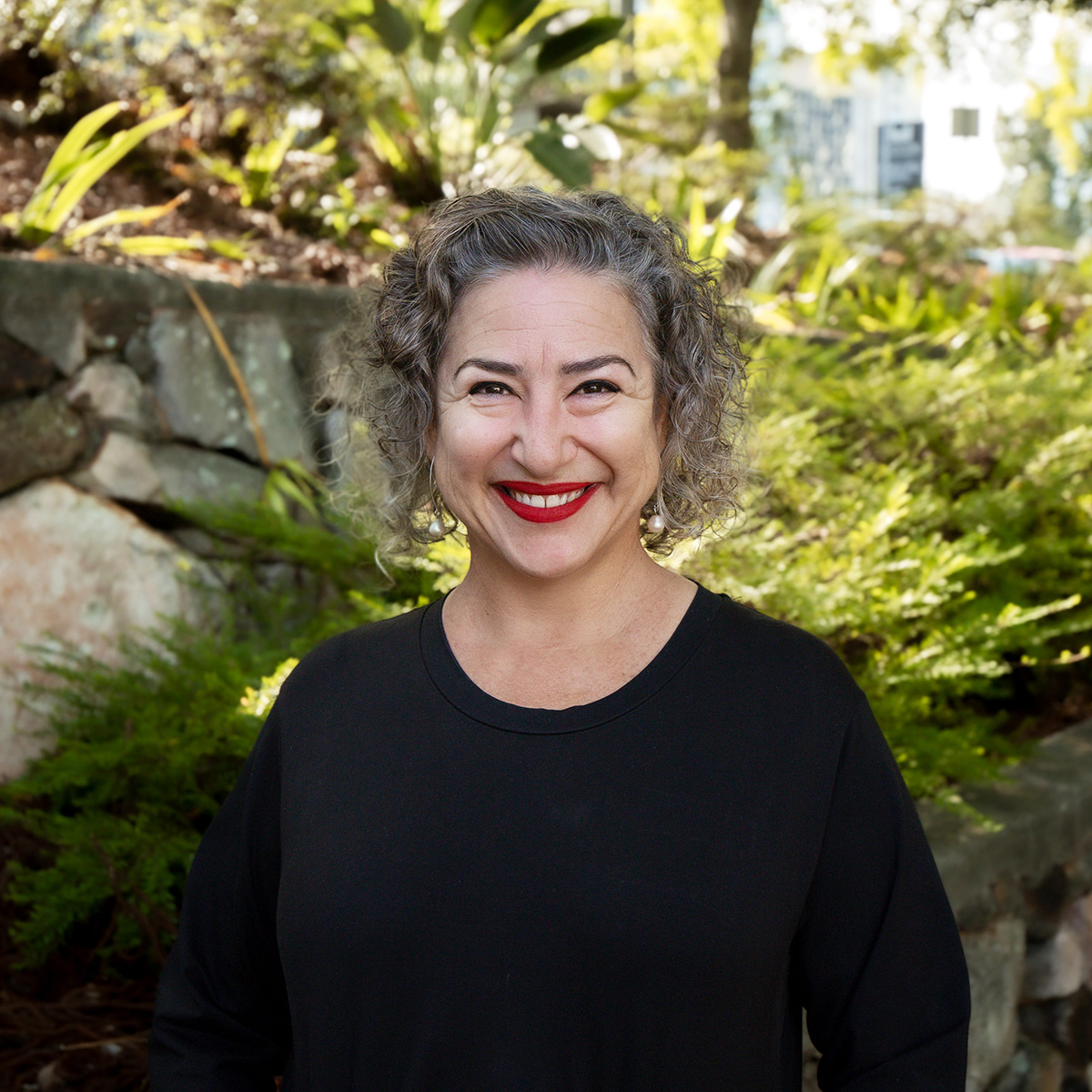 Fulton Trotter Director, Katerina Dracopoulos standing in Roma Street parkland smiling.