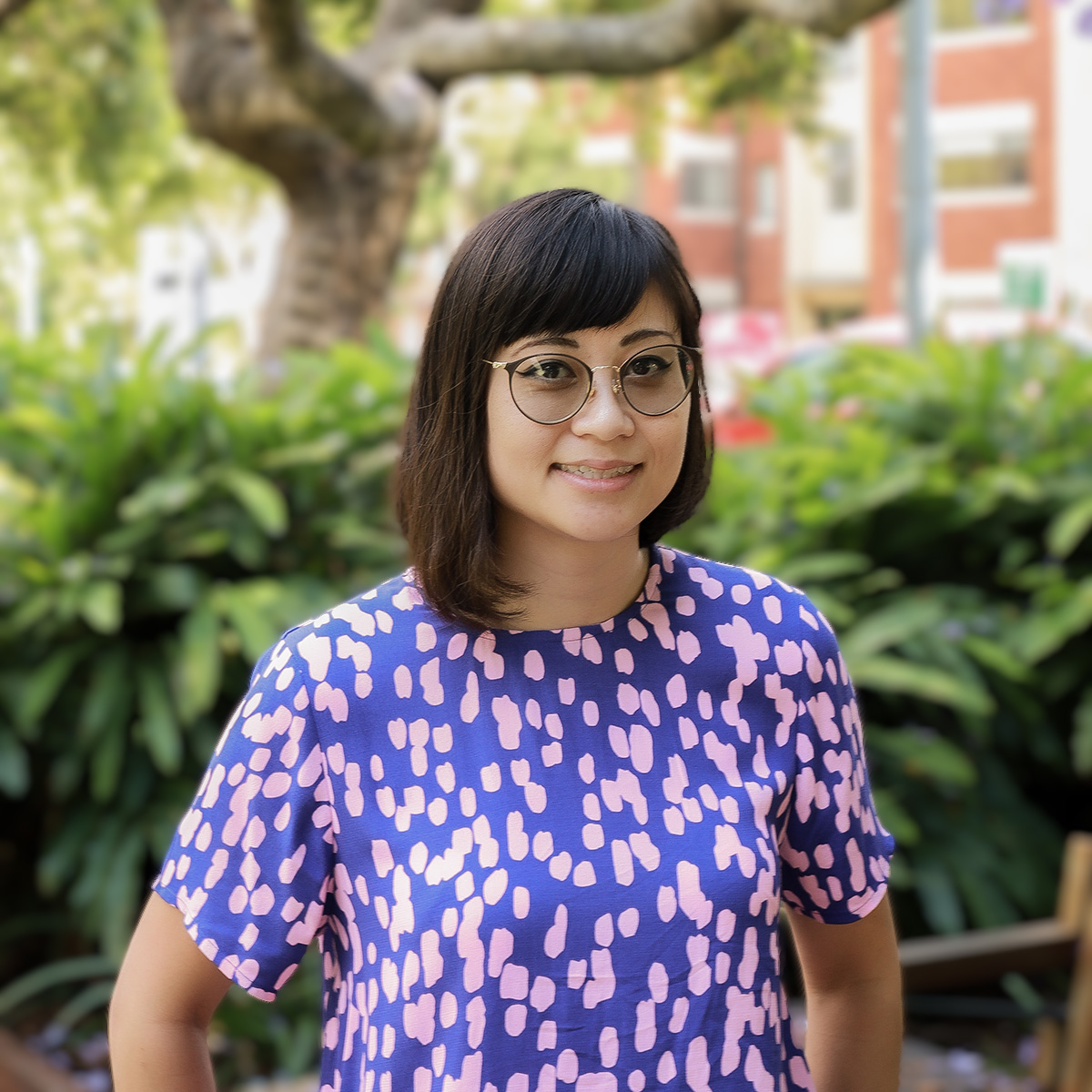 Fulton Trotter Associate Lily Nguyen smiling in Roma Street Parkland.