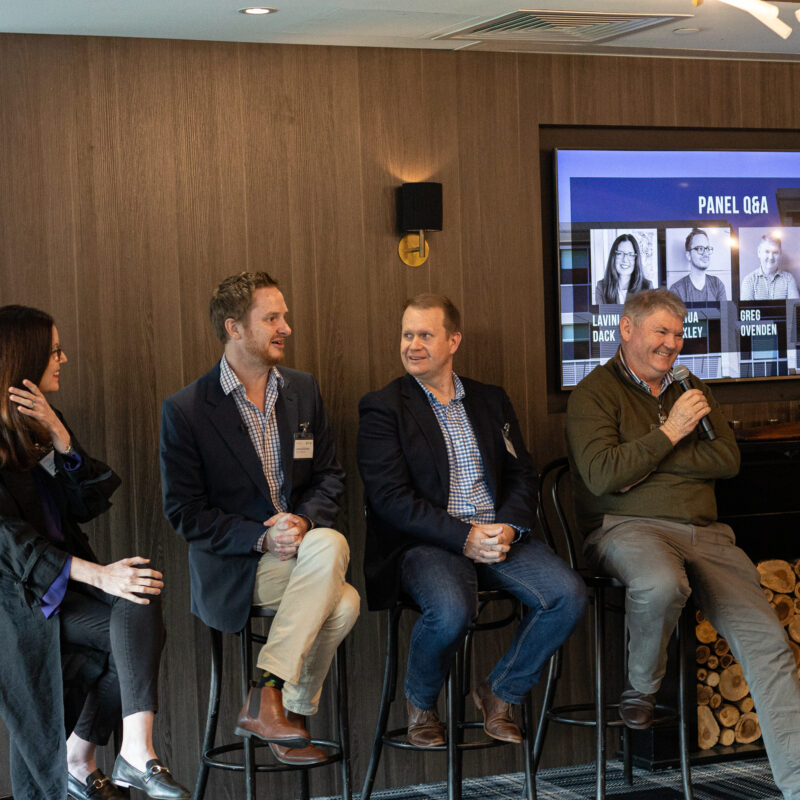 Fulton Trotter Forum event in May at Queensland Cricketers Club with Lavinia Dack, Group General Manager Property at UnitingCare Queensland, Senior Consultant at Urban Economics, Joshua Binkley, Fulton Trotter Architects Director, John Ward and Town Planner and Managing Director at Reel Planning, Greg Ovenden holding microphones and hosting a discussion panel on unlocking land value.