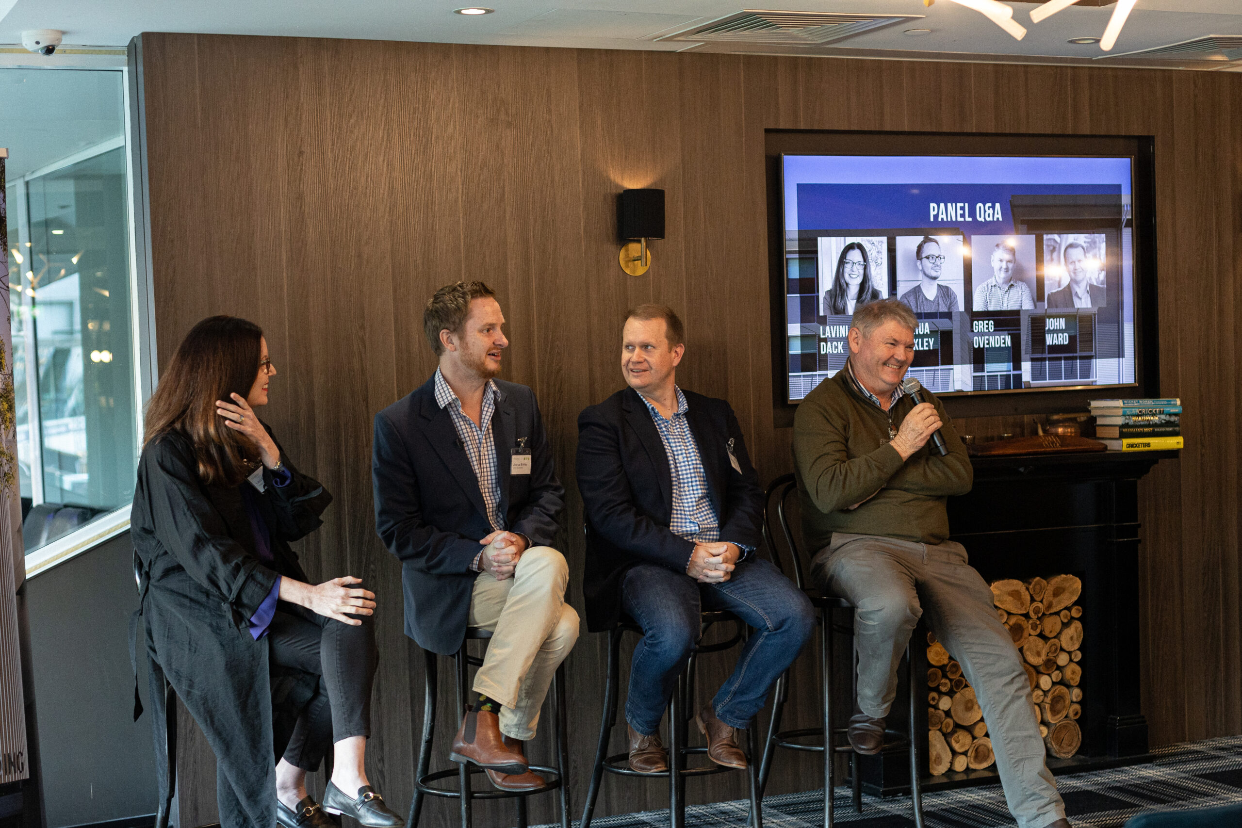 Fulton Trotter Forum event in May at Queensland Cricketers Club with Lavinia Dack, Group General Manager Property at UnitingCare Queensland, Senior Consultant at Urban Economics, Joshua Binkley, Fulton Trotter Architects Director, John Ward and Town Planner and Managing Director at Reel Planning, Greg Ovenden holding microphones and hosting a discussion panel on unlocking land value.