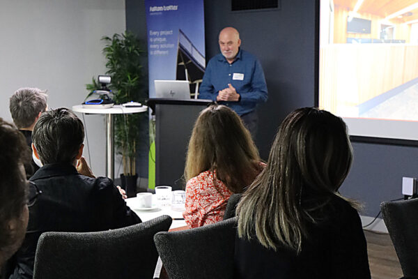 Associate John Hay presenting a project in a boardroom.