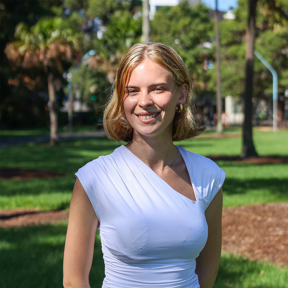 Anouk at the park wearing a white top